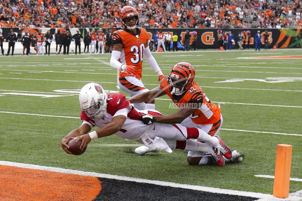 Gary Landers FILE - In this Oct. 6, 2019, file photo, Arizona Cardinals quarterback Kyler Murray (1) leaps in for a touchdown against Cincinnati Bengals cornerback William Jackson (22) in the first half of an NFL football game, in Cincinnati. Murray went to Arizona with the top pick a year after the Cardinals used a first-rounder on Josh Rosen and has lived up to the billing. Murray has thrown for 2,866 yards while starting every game, has thrown for 14 TDs compared to only six interceptions, and has rushed for 446 yards and four scores. (AP Photo/Gary Landers, File)