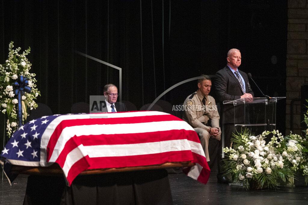 Silas Walker Floyd County Sheriff John Hunt speaks at the funeral for deputy William Petry at the Mountain Arts Center in Prestonsburg, Ky., Tuesday, July 5, 2022. Dep. Petry was killed when a man with a rifle opened fire on police attempting to serve a warrant Thursday, June 30. (Silas Walker/Lexington Herald-Leader via AP)