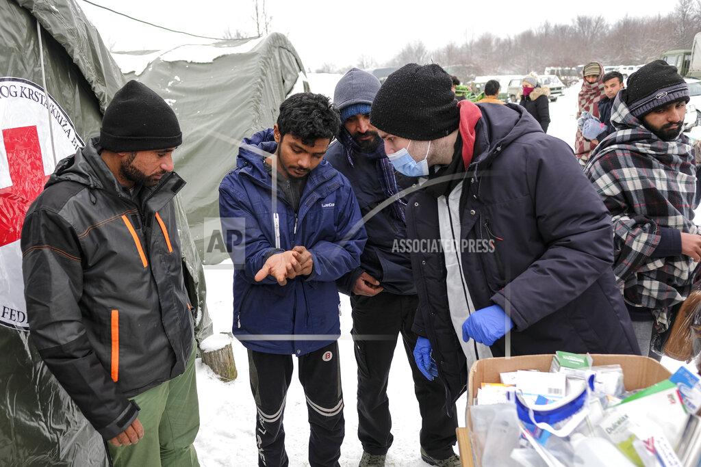 Kemal Softic Medical staff examine migrants at the Lipa camp, outside Bihac, Bosnia, Monday, Jan. 11, 2021. Aid workers say migrants staying at a camp in northwestern Bosnia have complained or respiratory and skin diseases after spending days in make-shift tents and containers amid freezing weather and snow blizzards. Most of the hundreds of migrants at the Lipa facility near Bosnia's border with Croatia on Monday have been accommodated in heated military tents following days of uncertainty after a fire gutted most of the camp on Dec. 23. (AP Photo/Kemal Softic)