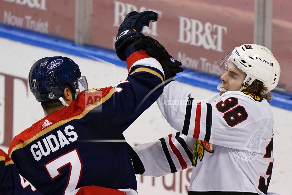 Wilfredo Lee Florida Panthers defenseman Radko Gudas (7) and Chicago Blackhawks left wing Brandon Hagel (38) scuffle during the third period of an NHL hockey game, Saturday, March 13, 2021, in Sunrise, Fla. (AP Photo/Wilfredo Lee)
