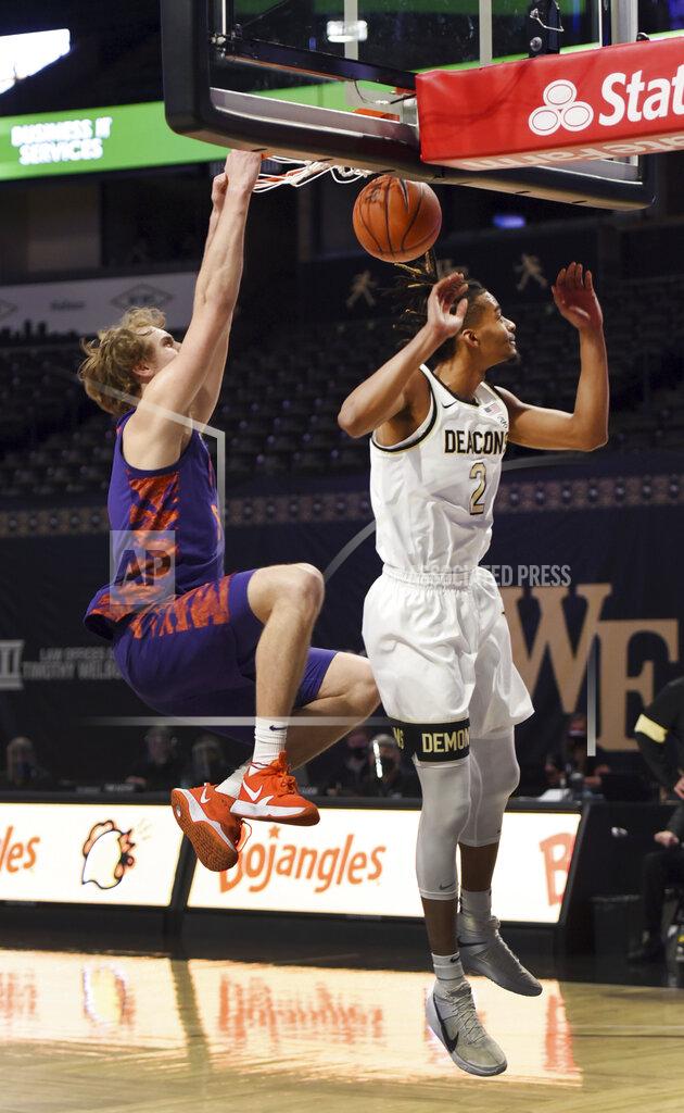 Walt Unks Clemson's Hunter Tyson dunks the ball over Wake Forest's Jalen Johnson during the first half of an NCAA college basketball game, Wednesday, Feb. 24, 2021 at Joel Coliseum in Winston-Salem, N.C. (Walt Unks/The Winston-Salem Journal via AP, Pool)