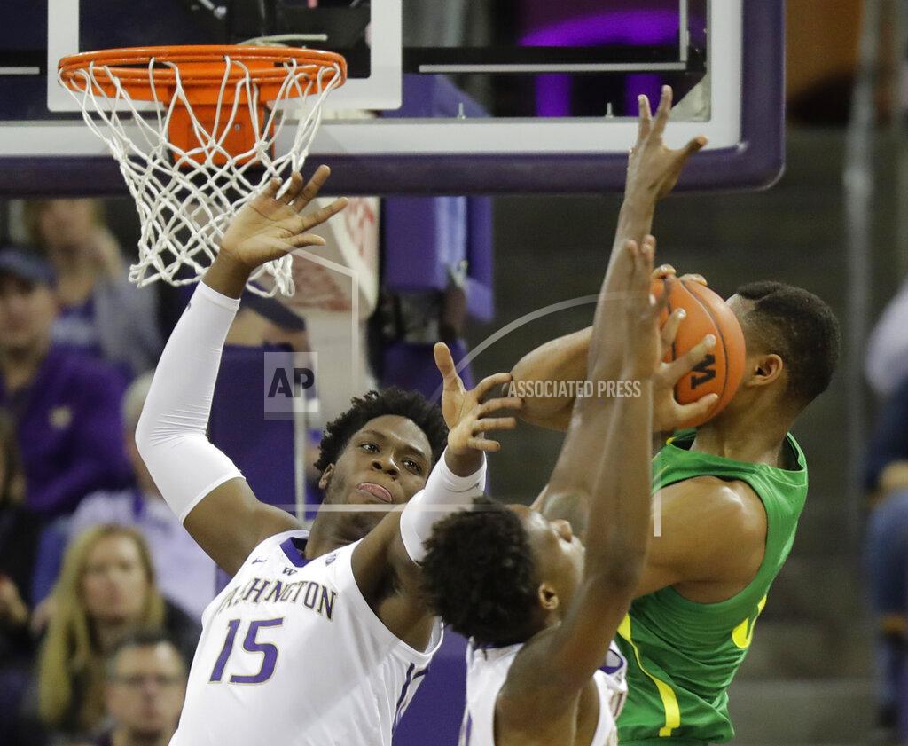 Ted S. Warren Washington forward Noah Dickerson (15) battles with Oregon forward Francis Okoro, right, for a rebound during the first half of an NCAA college basketball game, Saturday, March 9, 2019, in Seattle. (AP Photo/Ted S. Warren)