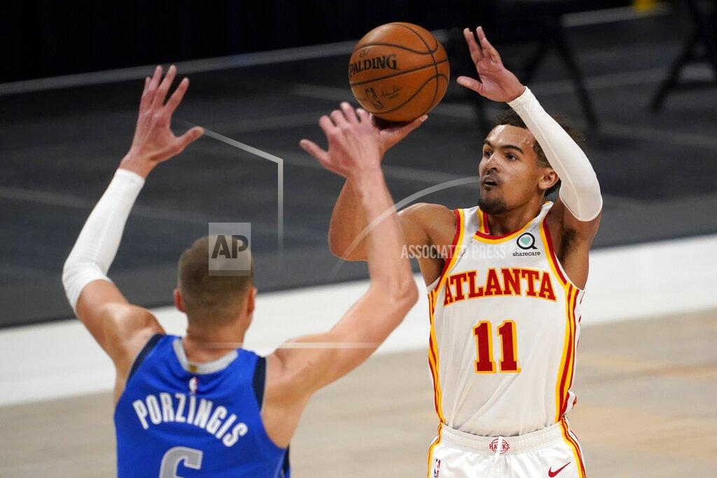 Tony Gutierrez Dallas Mavericks' Kristaps Porzingis (6) defends as Atlanta Hawks guard Trae Young (11) attempts a three-point basket in the first half of an NBA basketball game in Dallas, Wednesday, Feb. 10, 2021. (AP Photo/Tony Gutierrez)