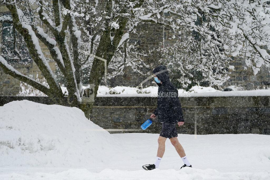 Matt Slocum A man walks through the snow during a winter storm, Sunday, Feb. 7, 2021, in Villanova, Pa. (AP Photo/Matt Slocum)