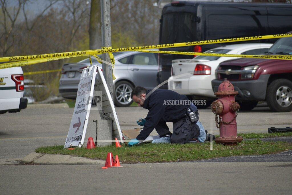Deneen Smith An investigator looks for evidence outside the Somers House Tavern in Somers, Wis., just outside of Kenosha, on Sunday, April 18, 2021, after a fatal shooting early Sunday morning. (Deneen Smith/The Kenosha News via AP)
