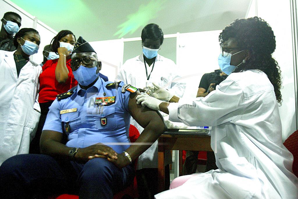 Diomande Ble Blonde Youssouf Kouyate, National Police General Director, receives a shot of the AstraZeneca vaccine in Abidjan, Ivory Coast, Monday March 1, 2021. Ivory Coast is the second country in the world after Ghana to receive vaccines acquired through the United Nations-backed COVAX initiative with a delivery of 504,000 doses of the AstraZeneca vaccine made by the Serum Institute of India. (AP Photo/ Diomande Ble Blonde)