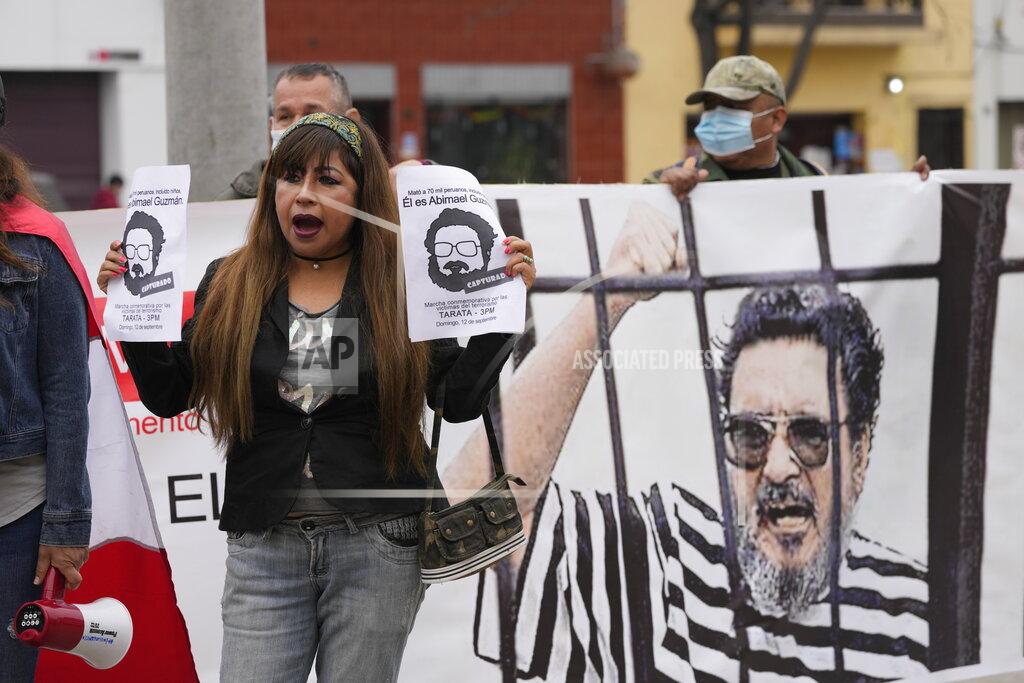 Martin Mejia People gather outside the anti-terrorism directorate to celebrate the death of Abimael Guzman, founder and leader of the Shining Path guerrilla movement, in Lima, Peru, Saturday, Sept. 11, 2021. Guzman, who was captured in 1992, died on Saturday in a military hospital after an illness, the Peruvian government said. He was 86. (AP Photo/Martin Mejia)