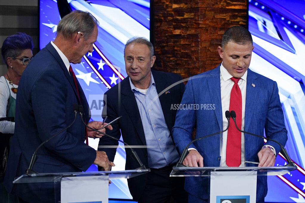 John Locher From left, North Las Vegas Mayor John Lee, Guy Nohra and Joey Gilbert great each other before a Republican primary debate for Nevada governor Wednesday, May 25, 2022, in Las Vegas. (AP Photo/John Locher, Pool)