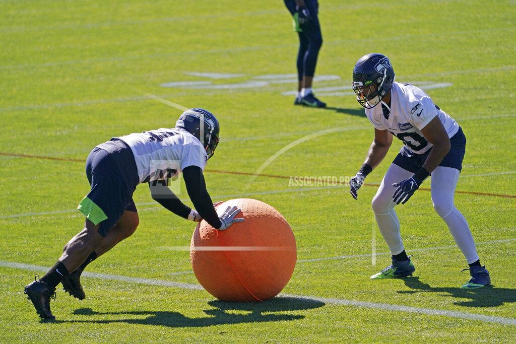 Ted S. Warren Seattle Seahawks linebacker Bobby Wagner, left, rolls a weighted ball with linebacker K.J. Wright, right, during NFL football training camp Tuesday, Sept. 1, 2020, in Renton, Wash. (AP Photo/Ted S. Warren)