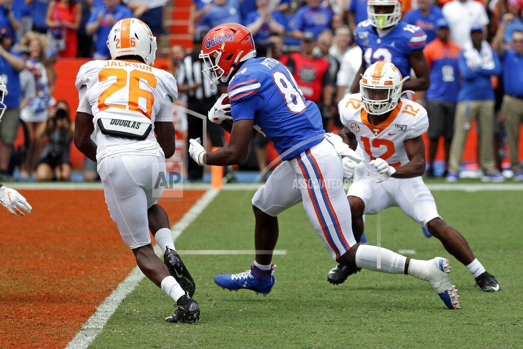 John Raoux Florida tight end Kyle Pitts, center, runs past Tennessee defensive back Theo Jackson (26) and defensive back Shawn Shamburger (12) for a touchdown on a 19-yard pass play during the first half of an NCAA college football game, Saturday, Sept. 21, 2019, in Gainesville, Fla. (AP Photo/John Raoux)
