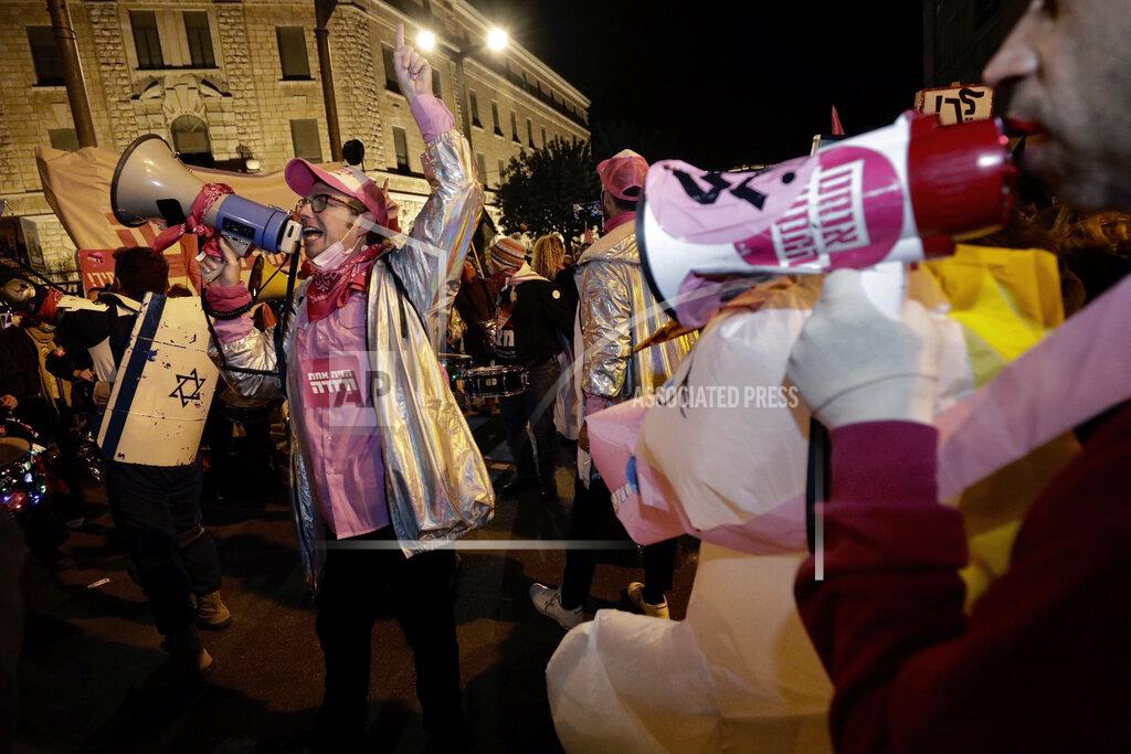 Sebastian Scheiner Israeli protesters chant slogans during a demonstration against Israeli Prime Minister Benjamin Netanyahu In Jerusalem, Saturday, Jan. 23, 2021. (AP Photo/Sebastian Scheiner)