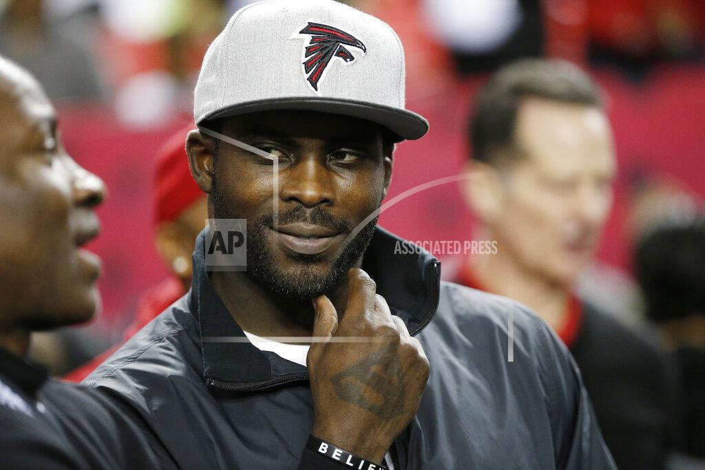 John Bazemore FILE - In this Jan. 1, 2017, file photo, former Atlanta Falcons quarterback Michael Vick stands on the sidelines before NFL football game between the Falcons and the New Orleans Saints in Atlanta. The former Virginia Tech and NFL quarterback is the subject of the latest edition of ESPN’s “30 for 30” documentary series. (AP Photo/John Bazemore, File)