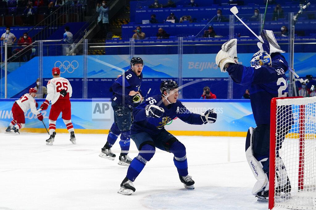 Matt Slocum Finland's Atte Ohtamaa (55) and Ville Pokka (2) celebrate with goalkeeper Harri Sateri, right, after Finland defeated Russian Olympic Committee to win the men's gold medal hockey game at the 2022 Winter Olympics, Sunday, Feb. 20, 2022, in Beijing. (AP Photo/Matt Slocum)