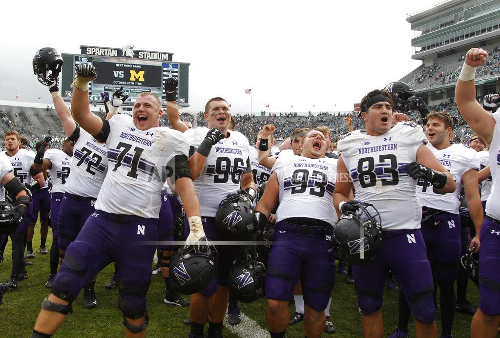 Al Goldis Northwestern players, including Tommy Doles (71), Trevor Kent (96), Joe Spivak (93) and Will Lansbury (83), celebrate an NCAA college football game against Michigan State, Saturday, Oct. 6, 2018, in East Lansing, Mich. Northwestern won 29-19. (AP Photo/Al Goldis)