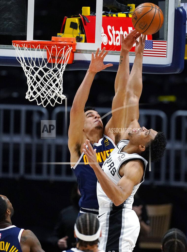 David Zalubowski Denver Nuggets forward Michael Porter Jr., left, blocks a last-second shot by San Antonio Spurs forward Keldon Johnson in the second half of an NBA basketball game Friday, April 9, 2021, in Denver. (AP Photo/David Zalubowski)