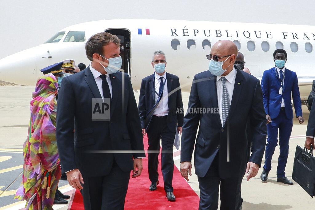 Ludovic Marin French President Emmanuel Macron, left, is welcomed by Mauritania President Mohamed Ould Ghazouani, right, upon arrival at Nouakchott Oumtounsy International Airport Tuesday June 30, 2020, in Nouakchott, to attend a G5 Sahel summit. Leaders from the five countries of West Africa's Sahel region, Burkina Faso, Chad, Mali, Mauritania and Niger, meet with French President Emmanuel Macron and Spanish Prime Minister Pedro Sanchez in Mauritania's capital Nouakchott on Tuesday to discuss military operations against Islamic extremists in the region, as jihadist attacks mount. The five African countries, known as the G5, have formed a joint military force that is working with France, which has thousands of troops to battle the extremists in the Sahel, the region south of the Sahara Desert. (Ludovic Marin, Pool via AP)