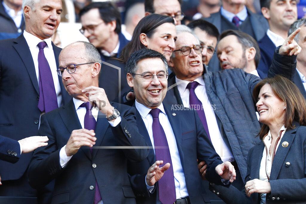 Barcelona's President Josep Maria Bartomeu, centre smiles as fans boo him during a Spanish La Liga soccer match between Barcelona and Eibar at the Camp Nou stadium in Barcelona, Spain, Saturday Feb. 22, 2020. (AP Photo/Joan Monfort)