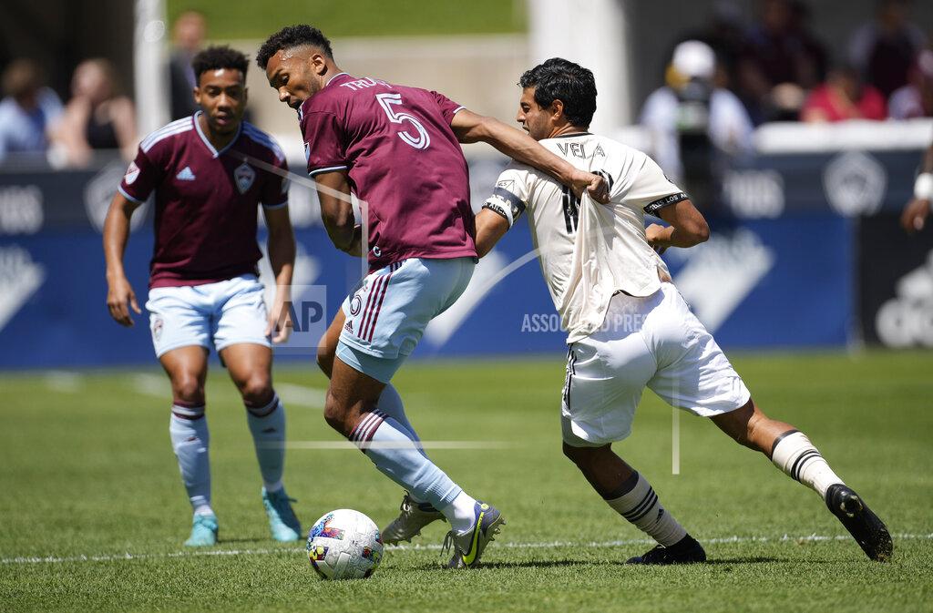 David Zalubowski Colorado Rapids defender Auston Trusty (5) fights for control of the ball with Los Angeles FC forward Carlos Vela, right, in the first half of an MLS soccer match Saturday, May 14, 2022, in Commerce City, Colo. (AP Photo/David Zalubowski)