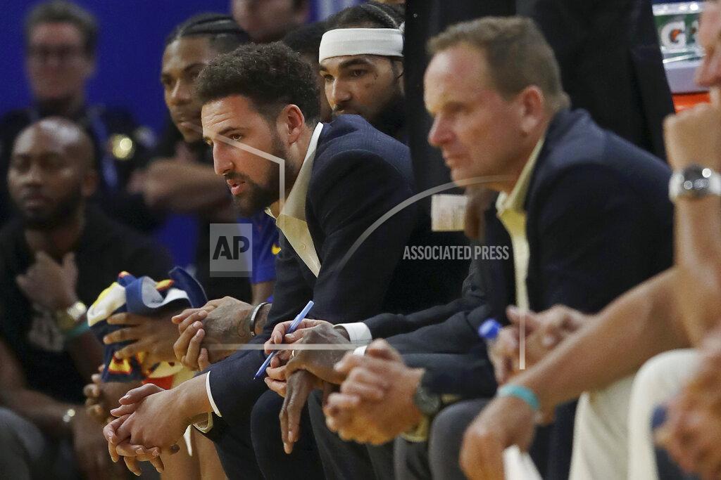 Jeff Chiu FILE - In this Nov. 4, 2019, file photo, injured Golden State Warriors guard Klay Thompson, center left, watches from the bench during the second half of an NBA basketball game against the Portland Trail Blazers in San Francisco. While Golden State is still dealing with the devastating news Splash Brother Klay Thompson will miss another season because of a torn right Achilles tendon that required surgery, everybody is eager for a fresh start.(AP Photo/Jeff Chiu, File)