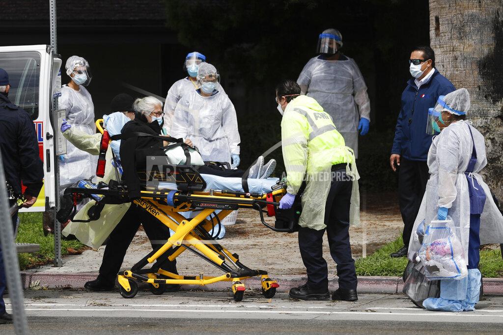 Chris Carlson A patient is evacuated from the Magnolia Rehabilitation and Nursing Center in Riverside, Calif., Wednesday, April 8, 2020. More than 80 patients from a Riverside skilled nursing facility are being evacuated this morning to other healthcare locations throughout Riverside County, Calif. (AP Photo/Chris Carlson)