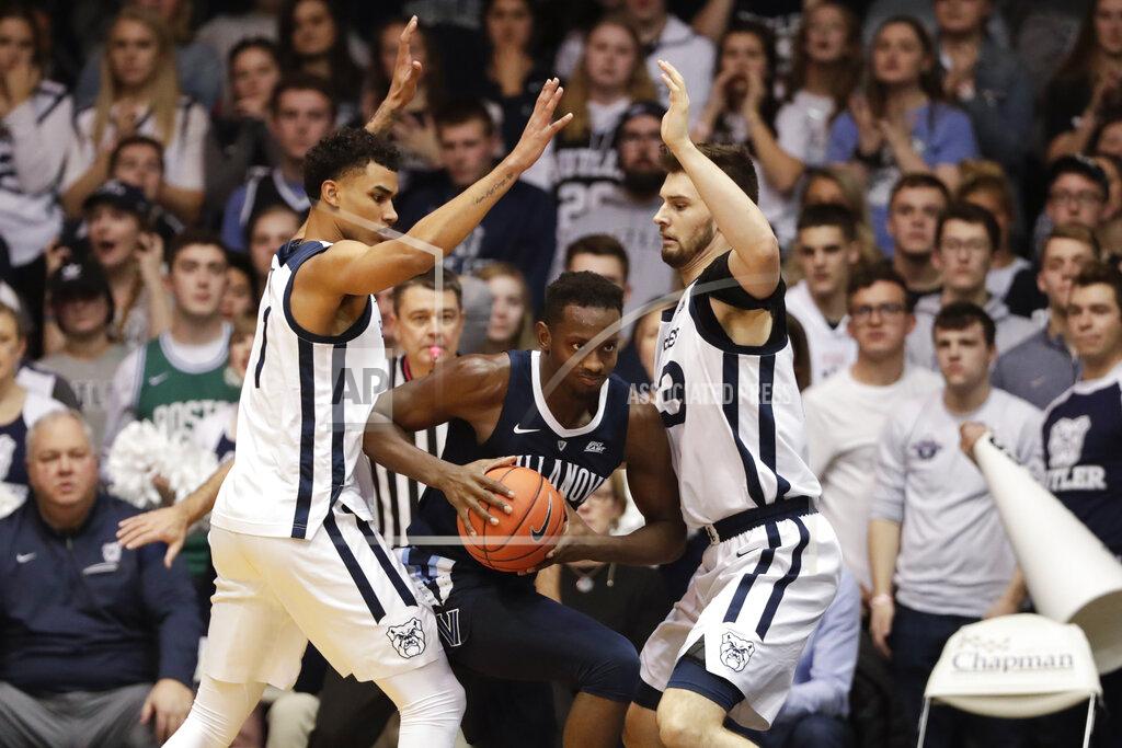 Michael Conroy Villanova forward Dhamir Cosby-Roundtree (21) cuts between Butler forward Jordan Tucker (1) and forward Bryce Golden (33) in the second half of an NCAA college basketball game in Indianapolis, Tuesday, Jan. 22, 2019. Villanova defeated Butler 80-72. (AP Photo/Michael Conroy)