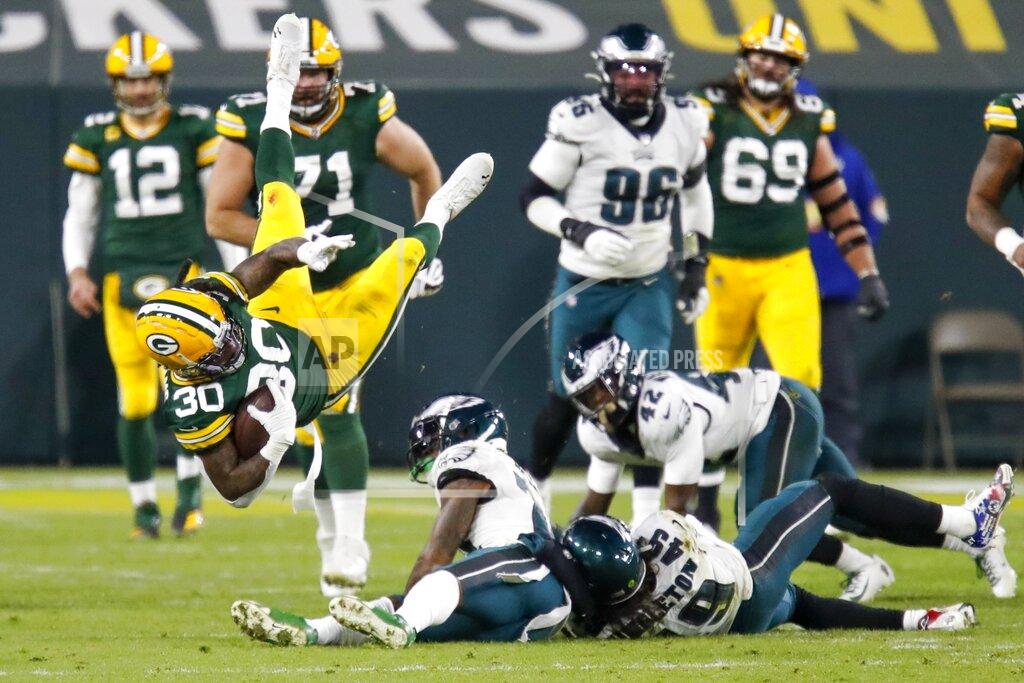 Matt Ludtke Green Bay Packers' Jamaal Williams is tripped up during the second half of an NFL football game against the Philadelphia Eagles Sunday, Dec. 6, 2020, in Green Bay, Wis. (AP Photo/Matt Ludtke)