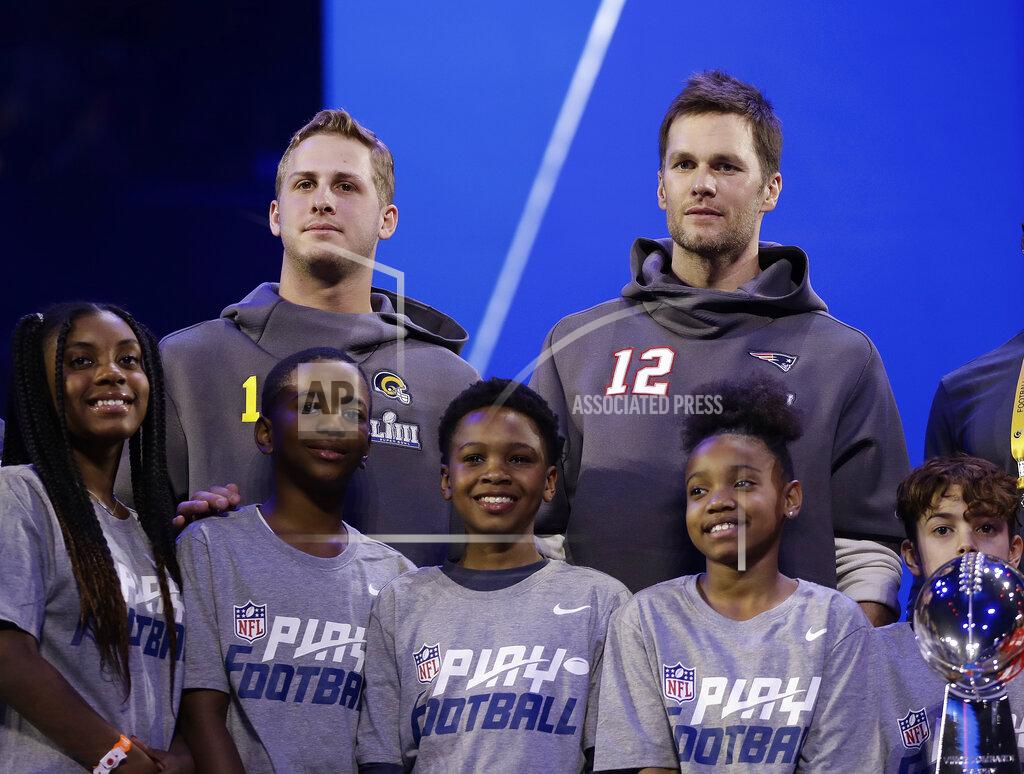 Matt Rourke New England Patriots' Tom Brady and Los Angeles Rams' Jared Goff pose for a picture during Opening Night for the NFL Super Bowl 53 football game Monday, Jan. 28, 2019, in Atlanta. (AP Photo/Matt Rourke)