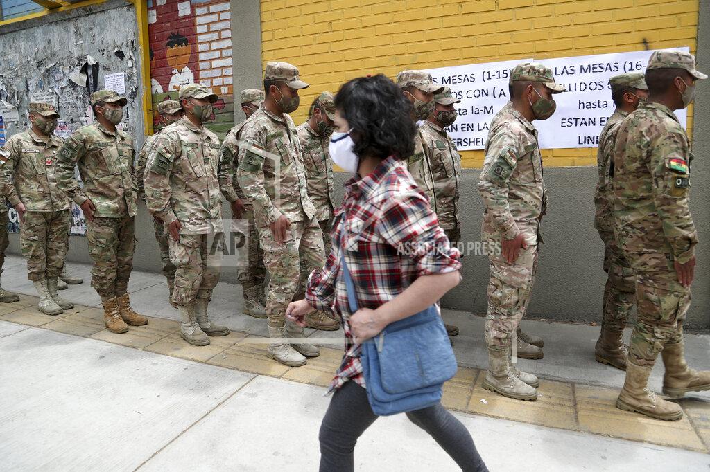 Martin Mejia Military police stand in line outside a polling station for their turn to vote during general elections in La Paz, Bolivia, Sunday, Oct. 18, 2020. (AP Photo/Martin Mejia)