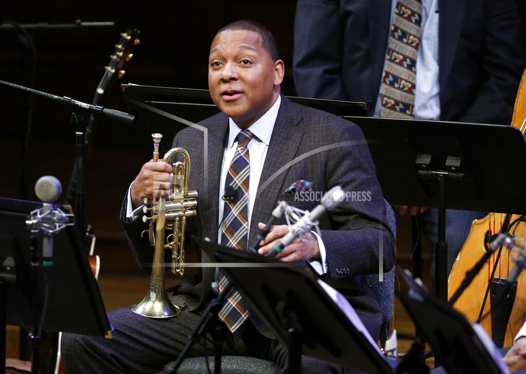 FILE - In this Jan. 30, 2014 file photo, Musician Wynton Marsalis speaks during a lecture performance at Harvard University's Sanders Theatre in Cambridge, Mass. The Louis Armstrong Educational Foundation has launched a $1 million emergency fund to support freelance New York City-area jazz musicians during the coronavirus pandemic. The fund will give one-time grants of $1,000 to jazz musicians that live in the New York City region and work regularly in the five boroughs of New York City. Marsalis, the Grammy-winning jazz icon is president of The Louis Armstrong Educational Foundation. (AP Photo/Elise Amendola, File)