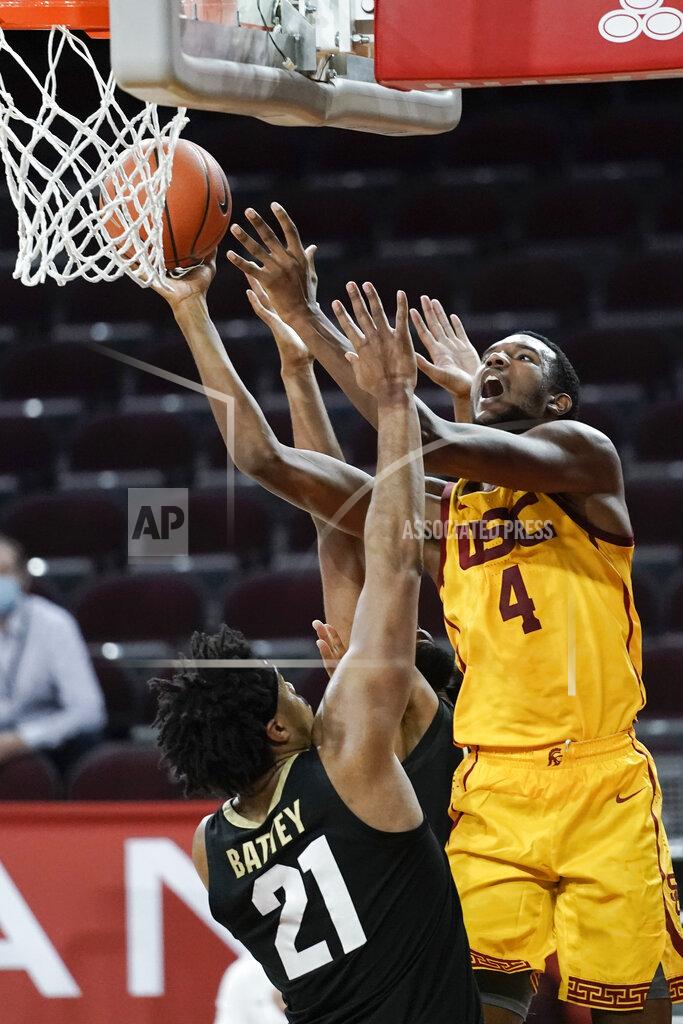 Jae C. Hong Southern California's Evan Mobley, right, shoots over Colorado's Evan Battey during the second half of an NCAA college basketball game, Thursday, Dec. 31, 2020, in Los Angeles. Colorado won 72-62. (AP Photo/Jae C. Hong)