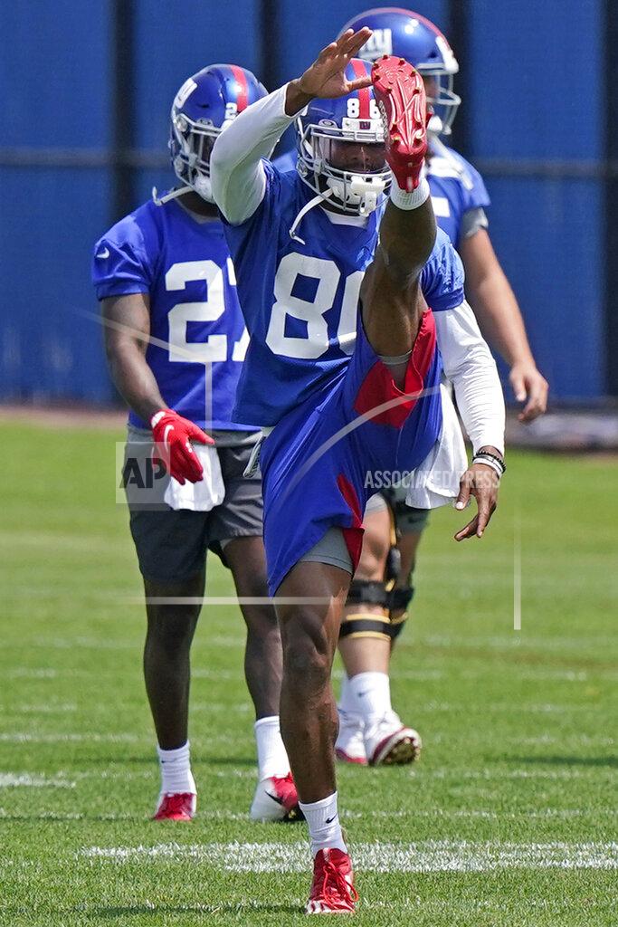 Kathy Willens New York Giants wide receiver Darius Slayton (86) warms up with teammates during an NFL football practice, Thursday, June 10, 2021, in East Rutherford, N.J. (AP Photo/Kathy Willens)
