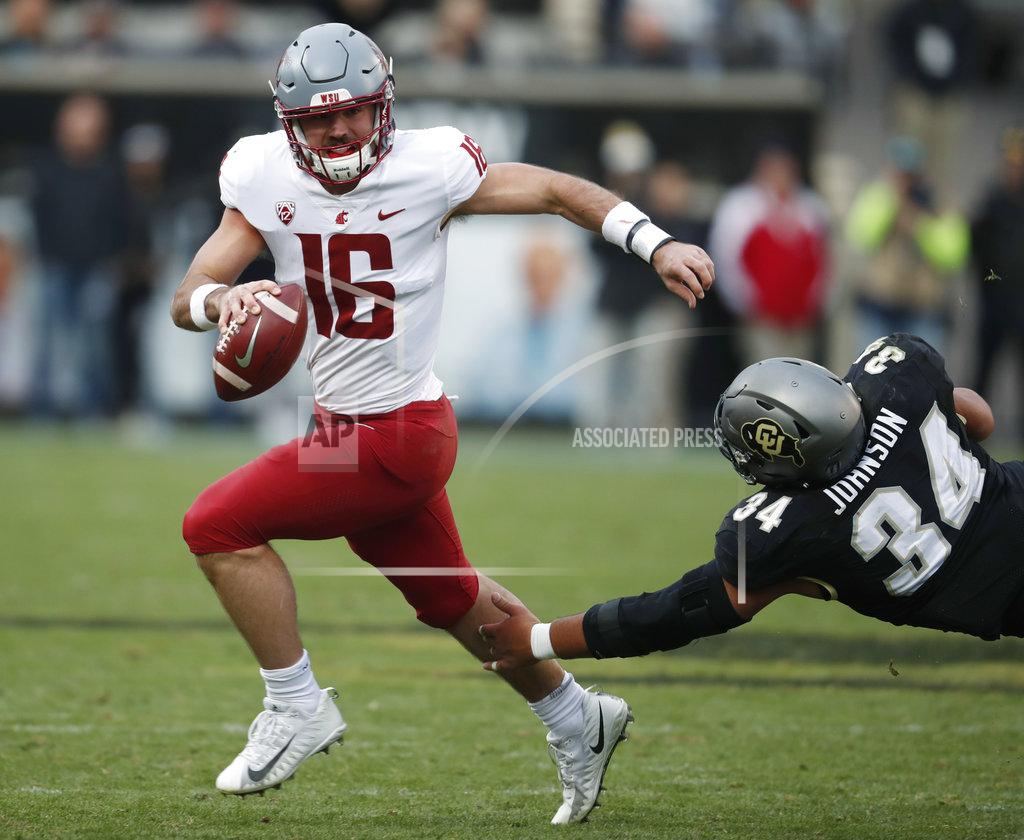 David Zalubowski Washington State quarterback Gardner Minshew, left, scrambles away from Colorado defensive lineman Mustafa Johnson in the second half of an NCAA college football game Saturday, Nov. 10, 2018, in Boulder, Colo. Washington State won 31-7. (AP Photo/David Zalubowski)