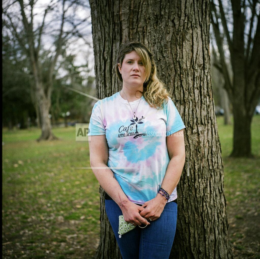 David Goldman In this photo made with a medium format film camera, Ashley Ellis, 34, stands for a portrait in Huntington, W.Va., Tuesday, March 16, 2021. Ellis started using drugs in college and has tried many times to stop using. She met the love of her life, Brandon Williams, when they were both in recovery. "He had the most beautiful soul of anyone I've ever known," she said. "He was just a beautiful person." But shortly after their child was born, they both relapsed. They lost everything. They were living together on the streets, and Ellis' mom took in their children. They slept in abandoned houses and on picnic tables. Ellis was hospitalized from an infection, and found her way to recovery again, but Williams kept using. She saw on Facebook that a body was found in an abandoned house and she knew it was him. She could feel it. She dreads one day having to tell her children he died of an overdose. Now she's determined to remain in recovery. "I think losing Brandon has been, quite possibly, what's going to save my life." (AP Photo/David Goldman)