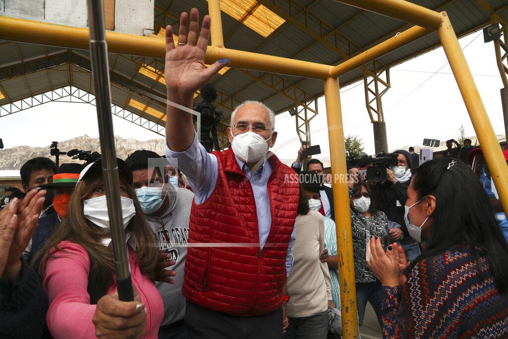 Martin Mejia Carlos Mesa, who is running for president with the Citizen Community party, waves to supporters after voting during general elections in La Paz, Bolivia, Sunday, Oct. 18, 2020. (AP Photo/Martin Mejia)