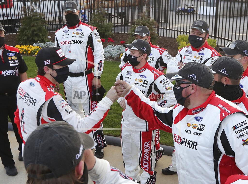 Curtis Compton Ryan Blaney, left, gives his pit crew fist-bumps after a NASCAR Cup Series auto race at Atlanta Motor Speedway on Sunday, March 21, 2021, in Hampton, Ga. (Curtis.Compton/Atlanta Journal-Constitution via AP)