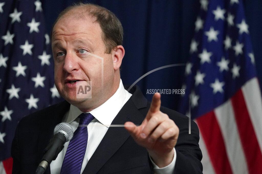 FILE - In this Nov. 13, 2020, file photo, Colorado Governor Jared Polis makes a point during a news conference about the state's rapid increase in coronavirus cases in Denver. Polis has announced a special COVID-19 legislative session to discuss a $220 million stimulus package to aid bars, restaurants, tenants, landlords and students. (AP Photo/David Zalubowski, File)