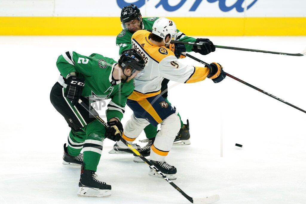 Tony Gutierrez Dallas Stars defenseman Jamie Oleksiak (2) and right wing Denis Gurianov (34) combine to strip the puck away from Nashville Predators forward Filip Forsberg during the first period of an NHL hockey game in Dallas, Friday, Jan. 22, 2021. (AP Photo/Tony Gutierrez)