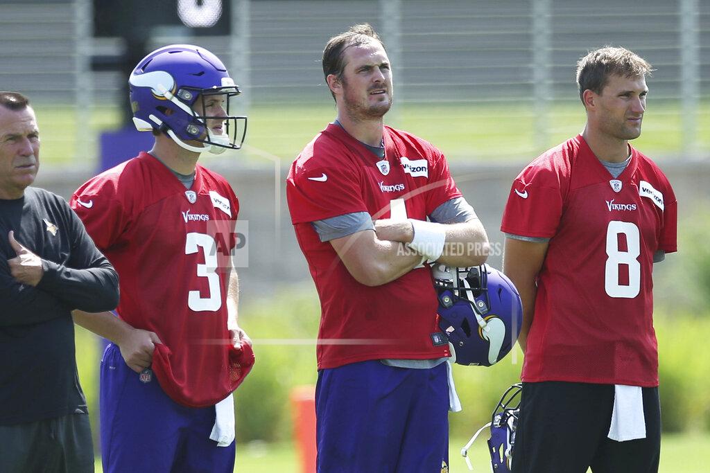 Jim Mone Minnesota Vikings quarterbacks, from left, Jake Browning, Sean Mannion and Kirk Cousins take a break during the NFL football team's training camp which opened with rookies and select veterans Tuesday July 23, 2019, in Eagan, Minn. (AP Photo/Jim Mone)