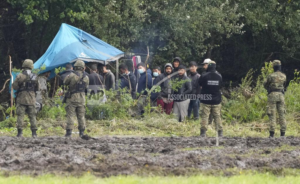 Czarek Sokolowski Polish security forces block migrants stuck on the border with Belarus in Usnarz Gorny, Poland, on Wednesday, Sept. 1, 2021. Poland's government said Monday that it is sending 500 additional troops and special vehicles to the border with Belarus to strengthen it against increasing migrant pressure that it says is orchestrated by Belarus and Russia. (AP Photo/Czarek Sokolowski)