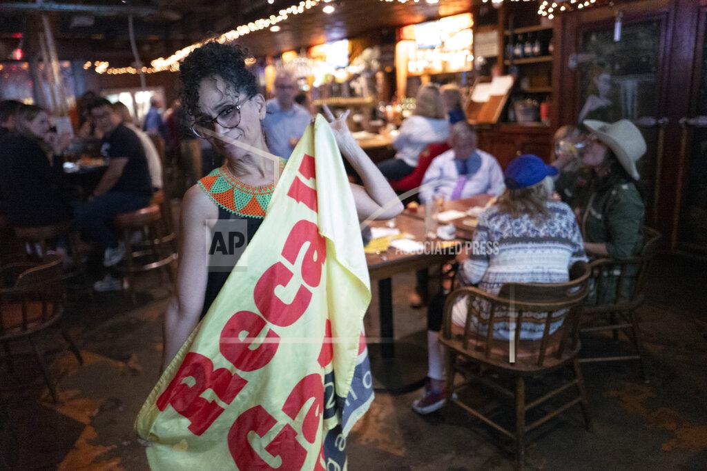 Richard Vogel Recall proponent, Roxanne Hoge holds up a recall Gavin Newsom flag at an election party at Pineapple Hill Saloon & Grill in Los Angeles on Tuesday, Sept. 14, 2021. Hoge was among a small group of pro-recall voters who gathered to watch the results come in. The mom of four said she was hopeful Newsom would be ousted, but was realistic that the chances were slim in Democratic-controlled California. (AP Photo/Richard Vogel)