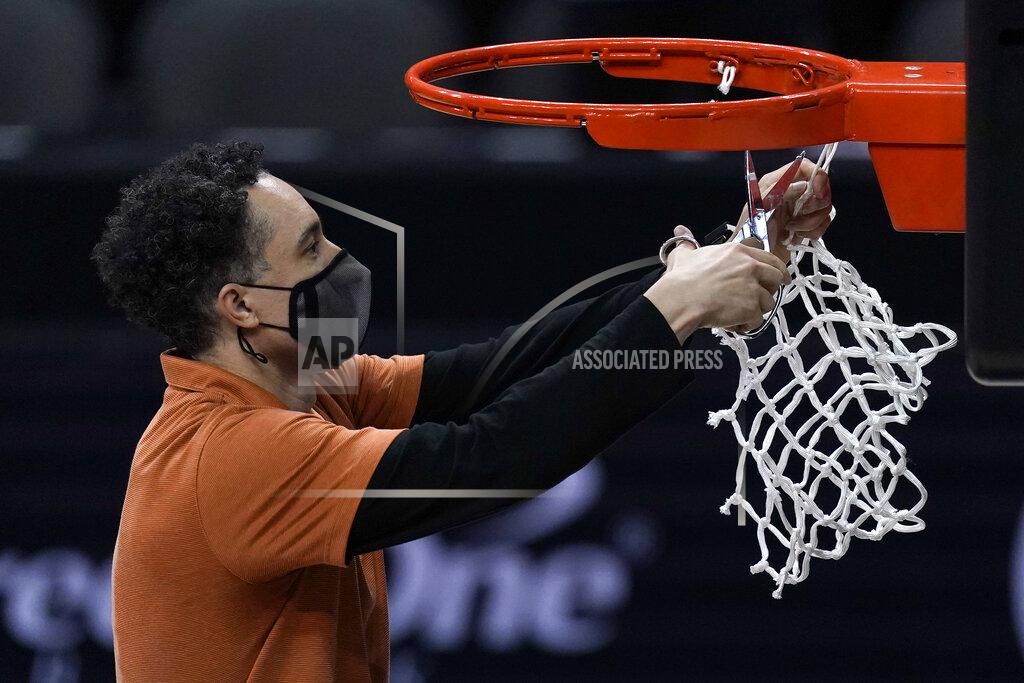 Charlie Riedel Texas head coach Shaka Smart cuts down the net after winning the Big 12 Tournament Championship NCAA college basketball game against Oklahoma State in Kansas City, Mo, Saturday, March 13, 2021. (AP Photo/Charlie Riedel)