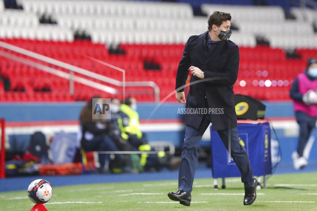 Thibault Camus PSG's head coach Mauricio Pochettino moves during the French League One soccer match between Paris Saint-Germain and Montpellier at the Parc des Princes stadium in Paris, France, Friday, Jan.22, 2021. (AP Photo/Thibault Camus)