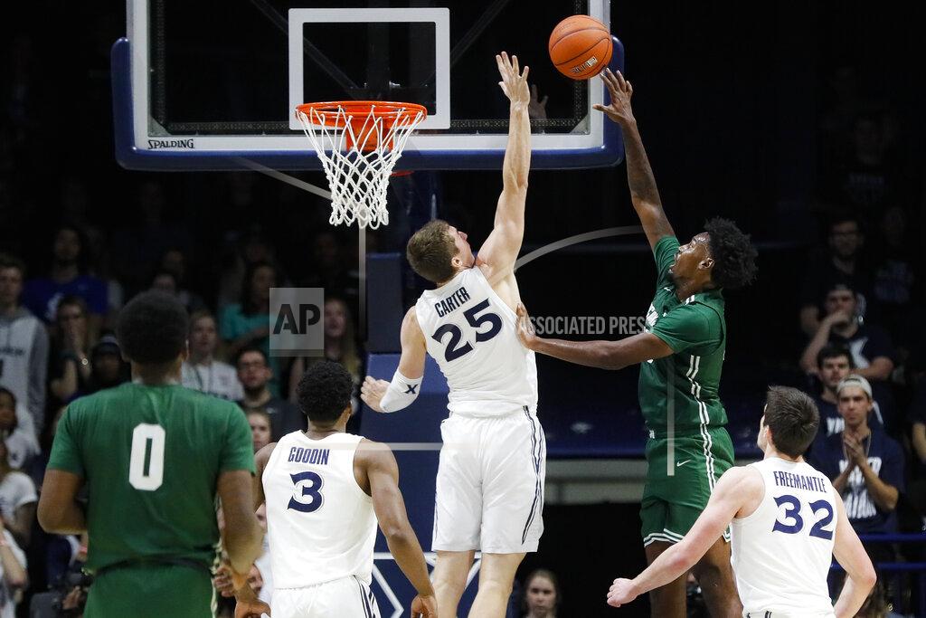 John Minchillo Jacksonville's Bryce Workman, right, shoots against Xavier's Jason Carter (25) during the second half of an NCAA college basketball game Tuesday, Nov. 5, 2019, in Cincinnati. (AP Photo/John Minchillo)