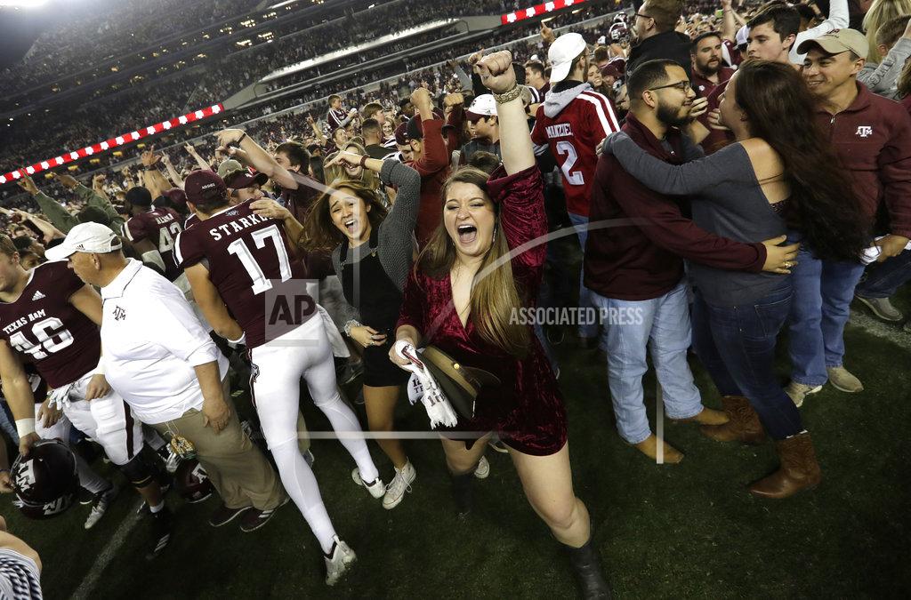 David J. Phillip Students and fans celebrate with Texas A&M football players after an NCAA college football game against LSU Saturday, Nov. 24, 2018, in College Station, Texas. Texas A&M won 74-72 in the seventh overtime. (AP Photo/David J. Phillip)