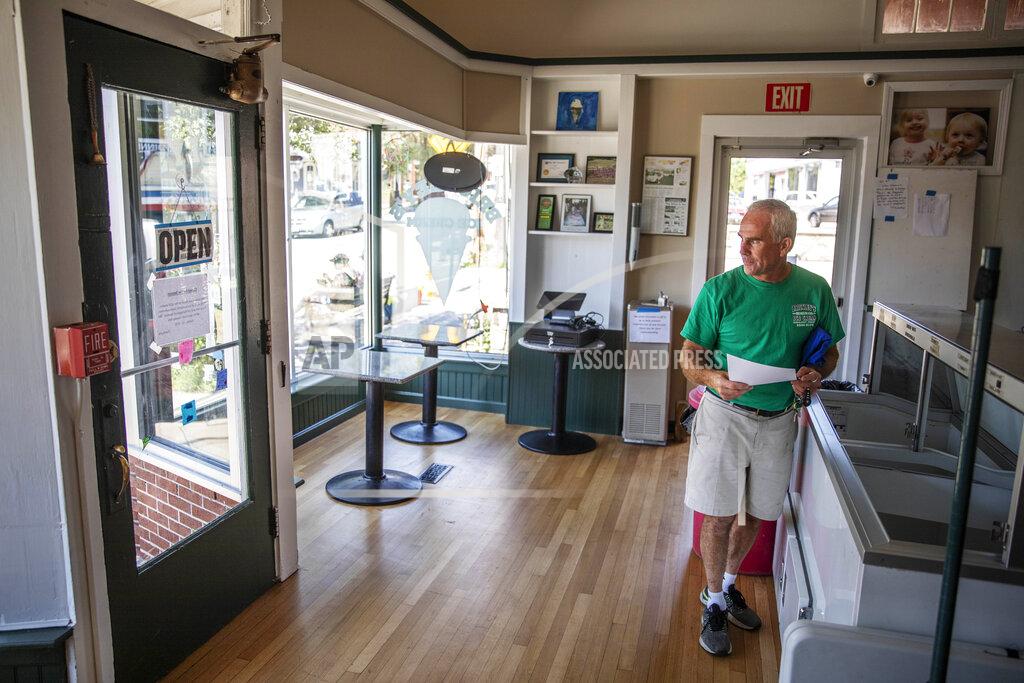 David Goldman Steve Brophy, owner of Brickley's Ice Cream, stands in the store he closed after teenage workers were harassed by customers who refused to wear a mask or socially distance, in Wakefield, R.I., Wednesday, July 29, 2020. Disputes over masks and mask mandates are playing out at businesses, on public transportation and in public places across America and other nations. (AP Photo/David Goldman)