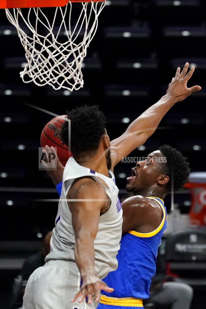 Nam Y. Huh Pittsburgh guard Xavier Johnson, right, drives to the basket against Northwestern guard Anthony Gaines during the first half of an NCAA college basketball game in Evanston, Ill., Wednesday, Dec. 9, 2020. (AP Photo/Nam Y. Huh)