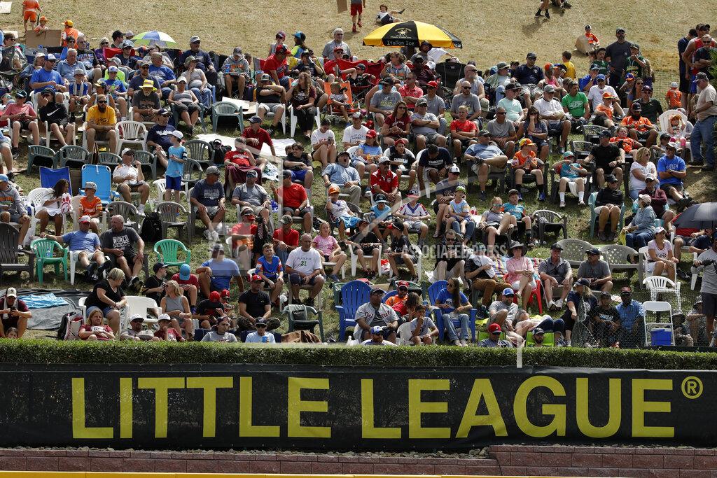 Gene J. Puskar In this Aug. 24, 2019, photo, Little League fans watch from the hillside overlooking left field at Lamade Stadium during the International Championship baseball game between Curacao and Japan at the Little League World Series tournament in South Williamsport, Pa. Little League has been benched. The youth baseball program that boasts more than 2.5 million kids spread over 6,500 programs in 84 countries is on hold at least until May 11 due to the corona virus pandemic. Even that target date for a return to the sports lineup seems optimistic, and the fate of its signature event, the Little League World Series in August in South Williamsport, Pennsylvania is unclear. (AP Photo/Gene J. Puskar)