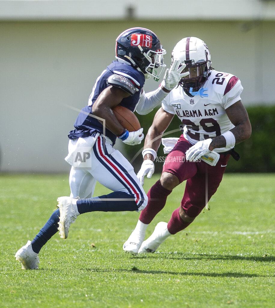 Eric Shelton Jackson State David Arrington IV tries to get past Alabama A&M's Trenton McGhee during an NCAA college football game, Saturday, April 10, 2021, at Veterans Memorial Stadium in Jackson, Miss. (Eric Shelton/The Clarion-Ledger via AP)