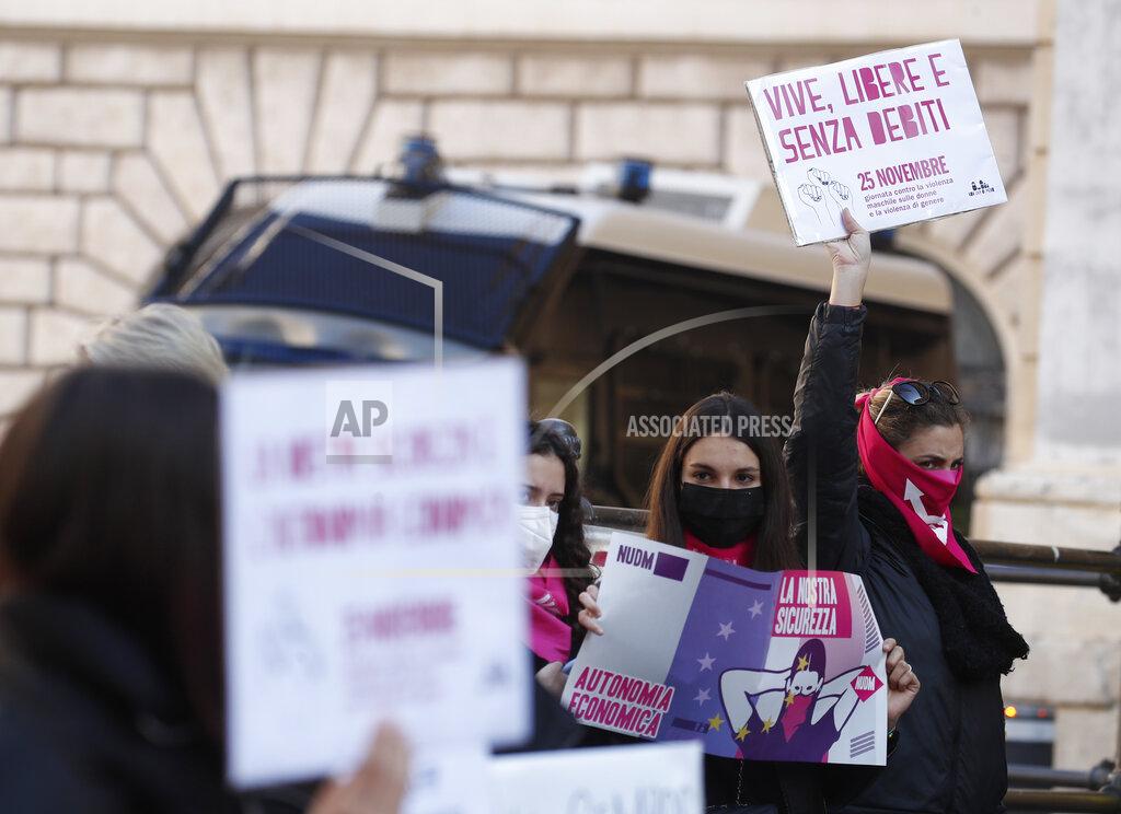 Alessandra Tarantino A woman show a banner reading "alive, free and without debts" during a demonstration on the occasion of International Day for the Elimination of Violence against Women, in Rome, Wednesday, Nov. 25, 2020. (AP Photo/Alessandra Tarantino)