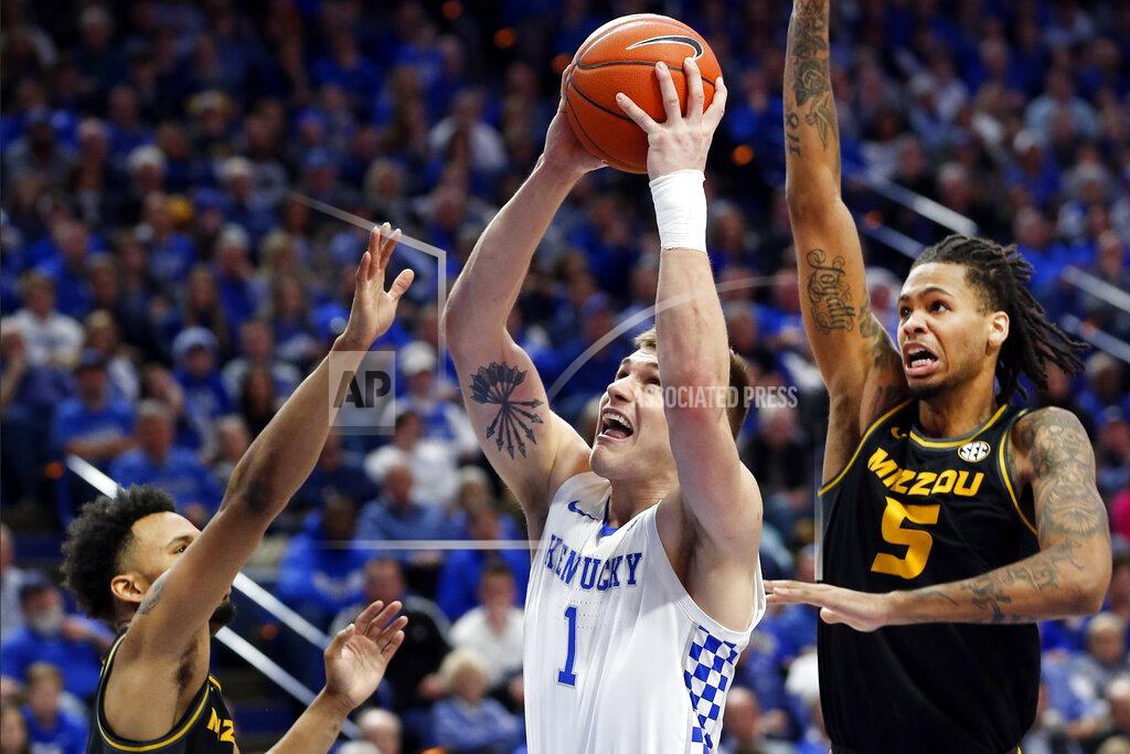 James Crisp Kentucky's Nate Sestina, middle, shoots between Missouri's Torrence Watson, left, and Mitchell Smith (5) during the second half of an NCAA college basketball game in Lexington, Ky., Saturday, Jan 4, 2020. Kentucky won 71-59. (AP Photo/James Crisp)